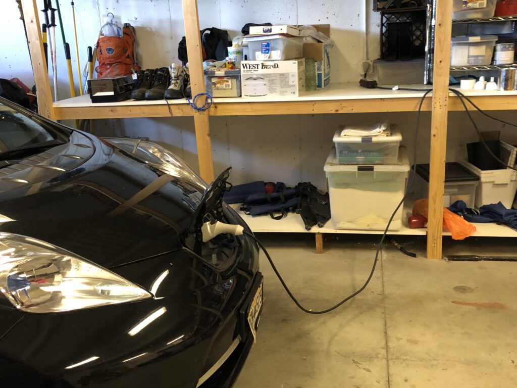 Nissan Leaf plugged into regular wall socket in garage